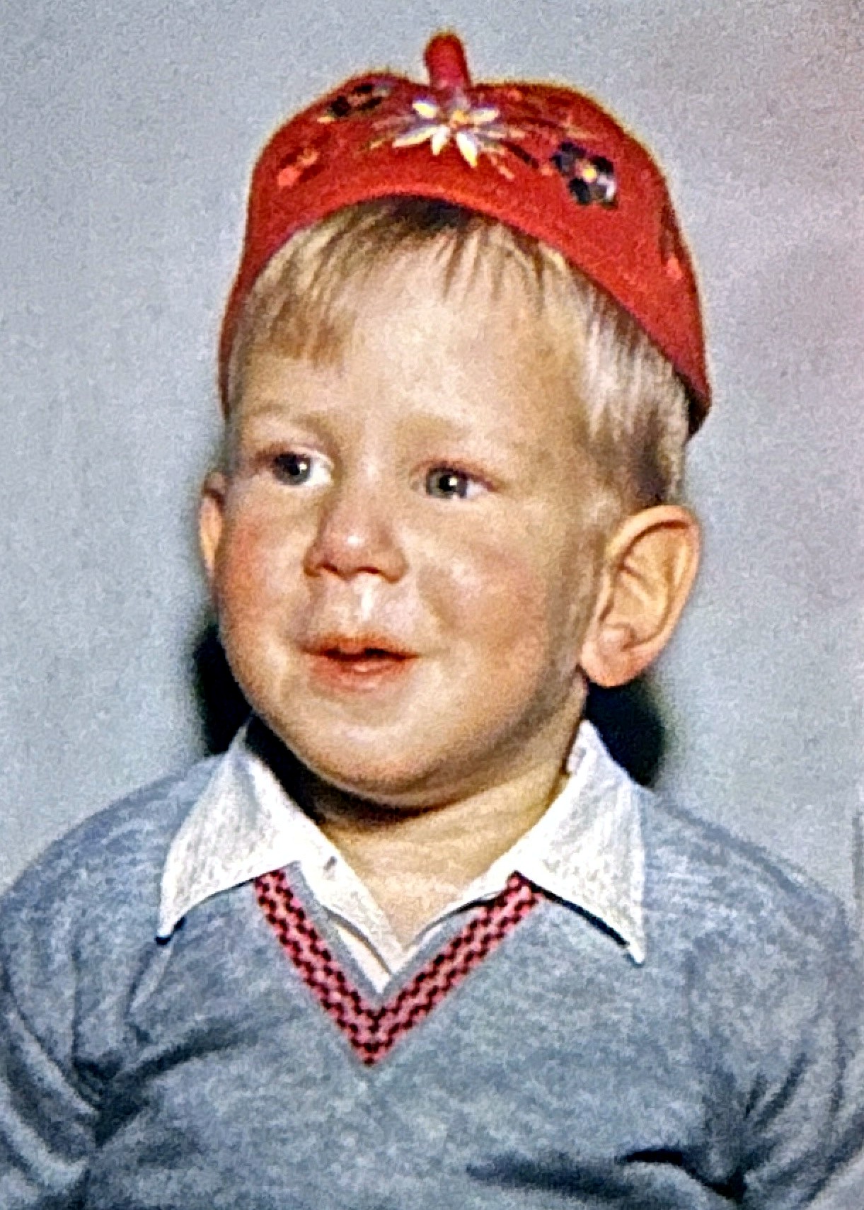 A young Rubenstein son in an embroidered red yarmulke