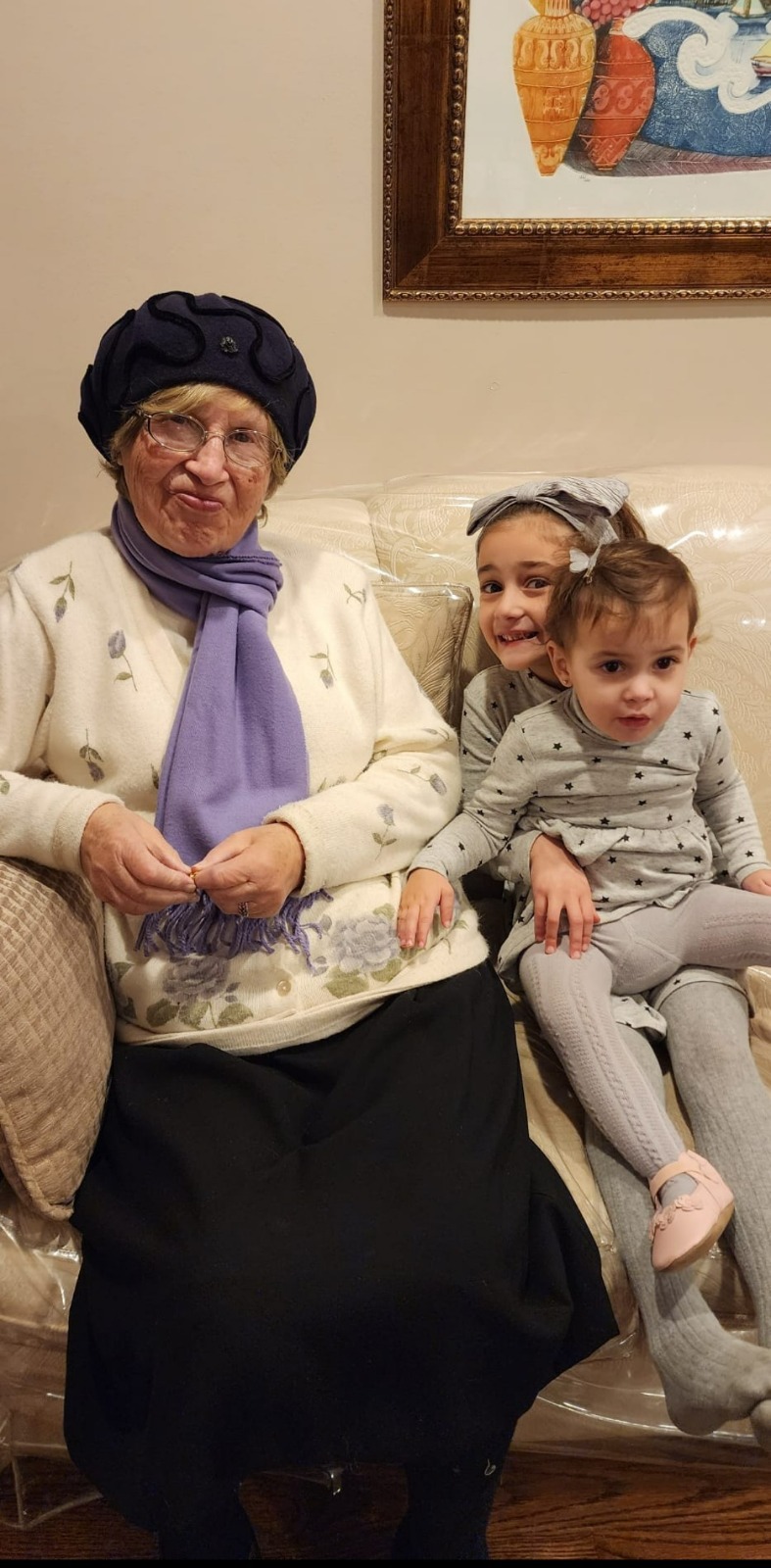 Bobby seated with two great-granddaughters