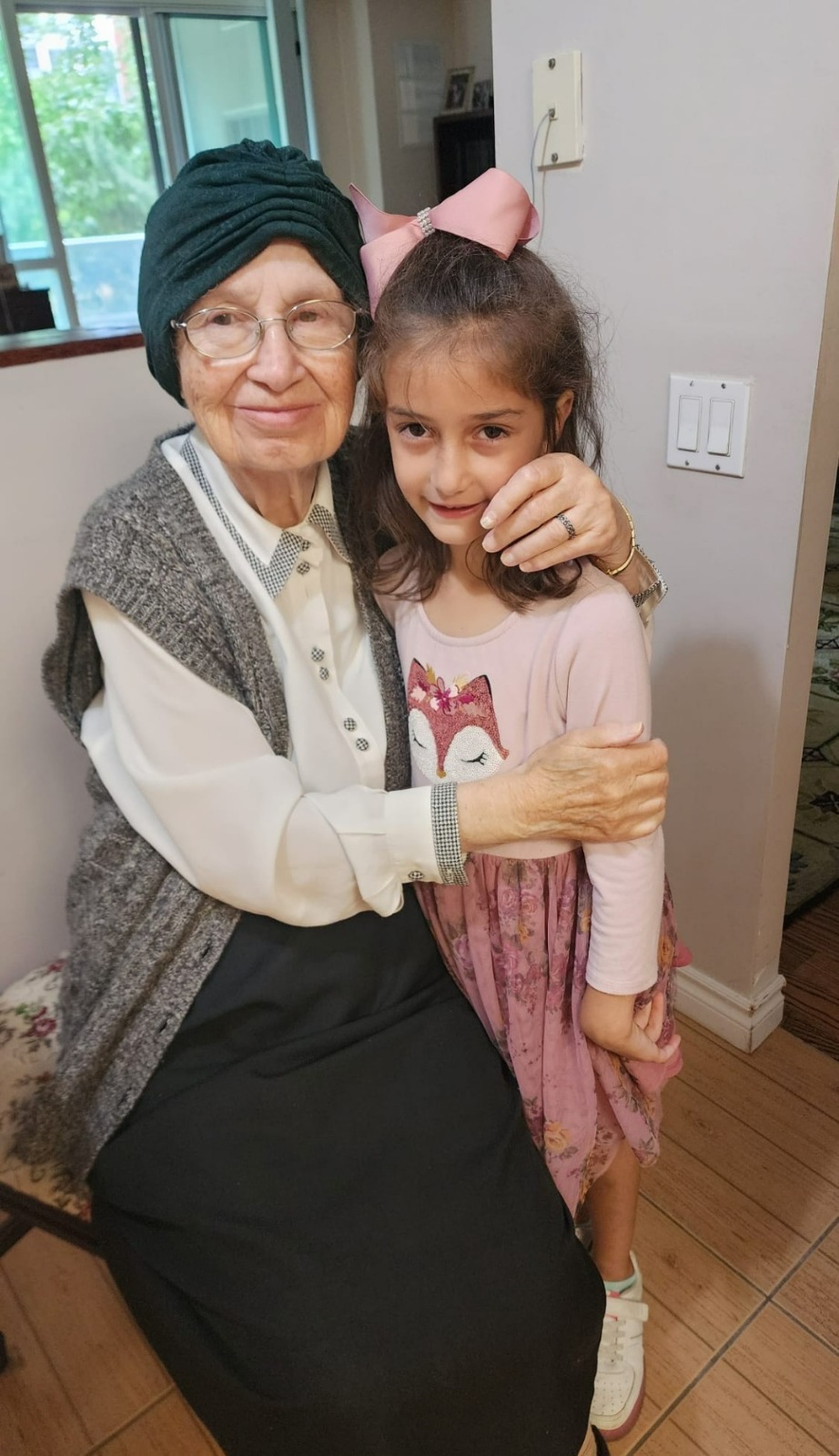 Bobby with her arm around a great-granddaughter