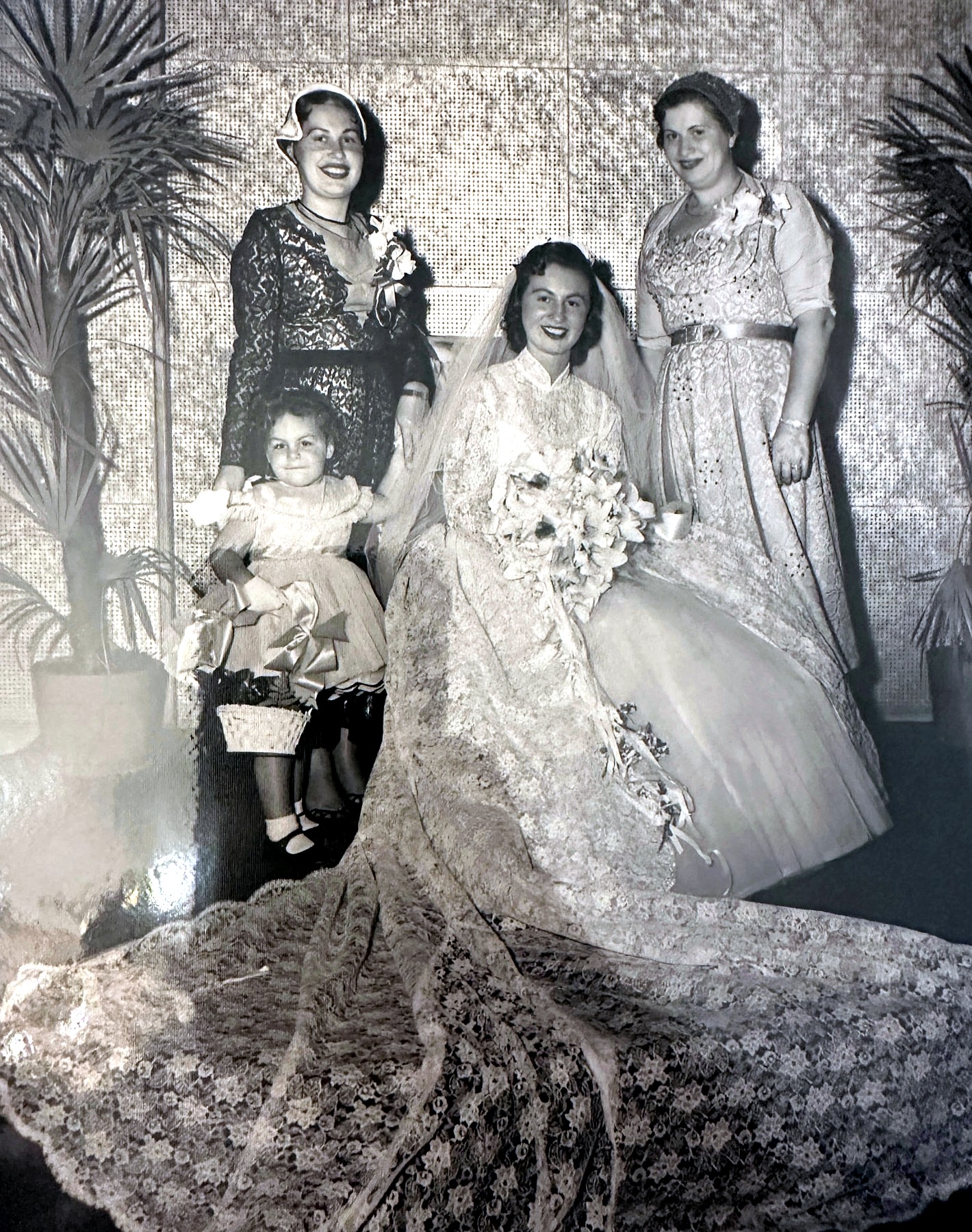 Esther as a bride with her mother, sister and the flower girl