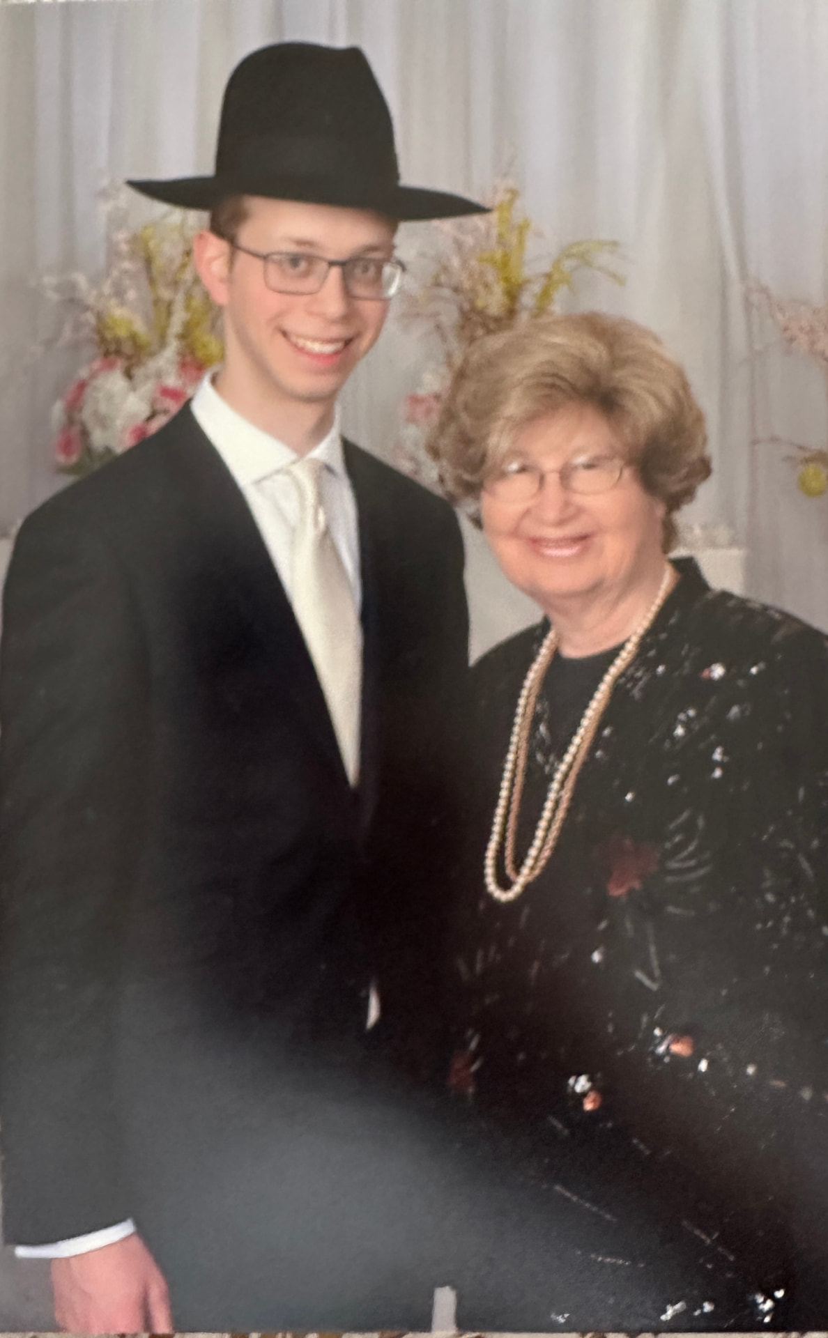 Bobby with the chosson under the flowers at a wedding