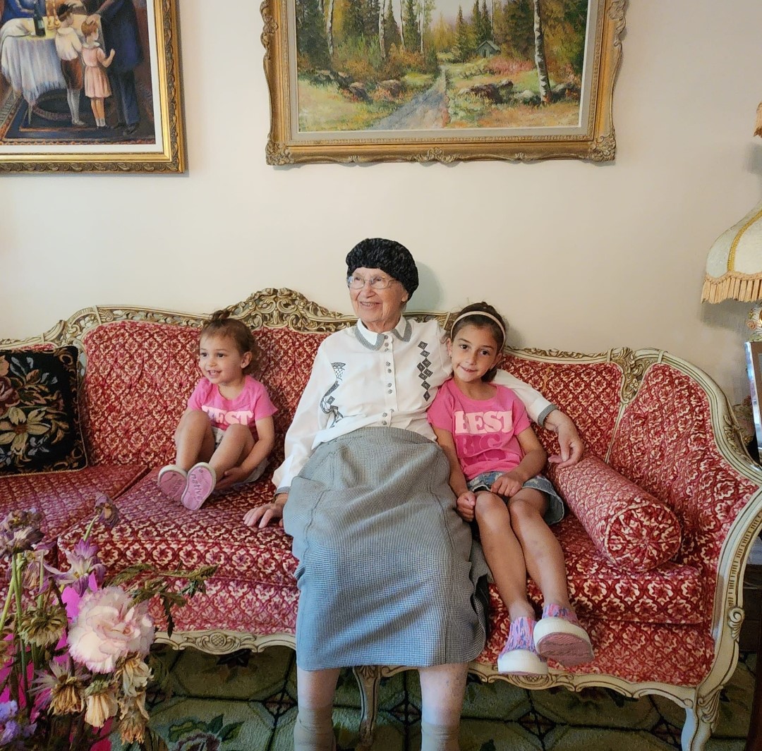 Bobby on the couch between two great-granddaughters