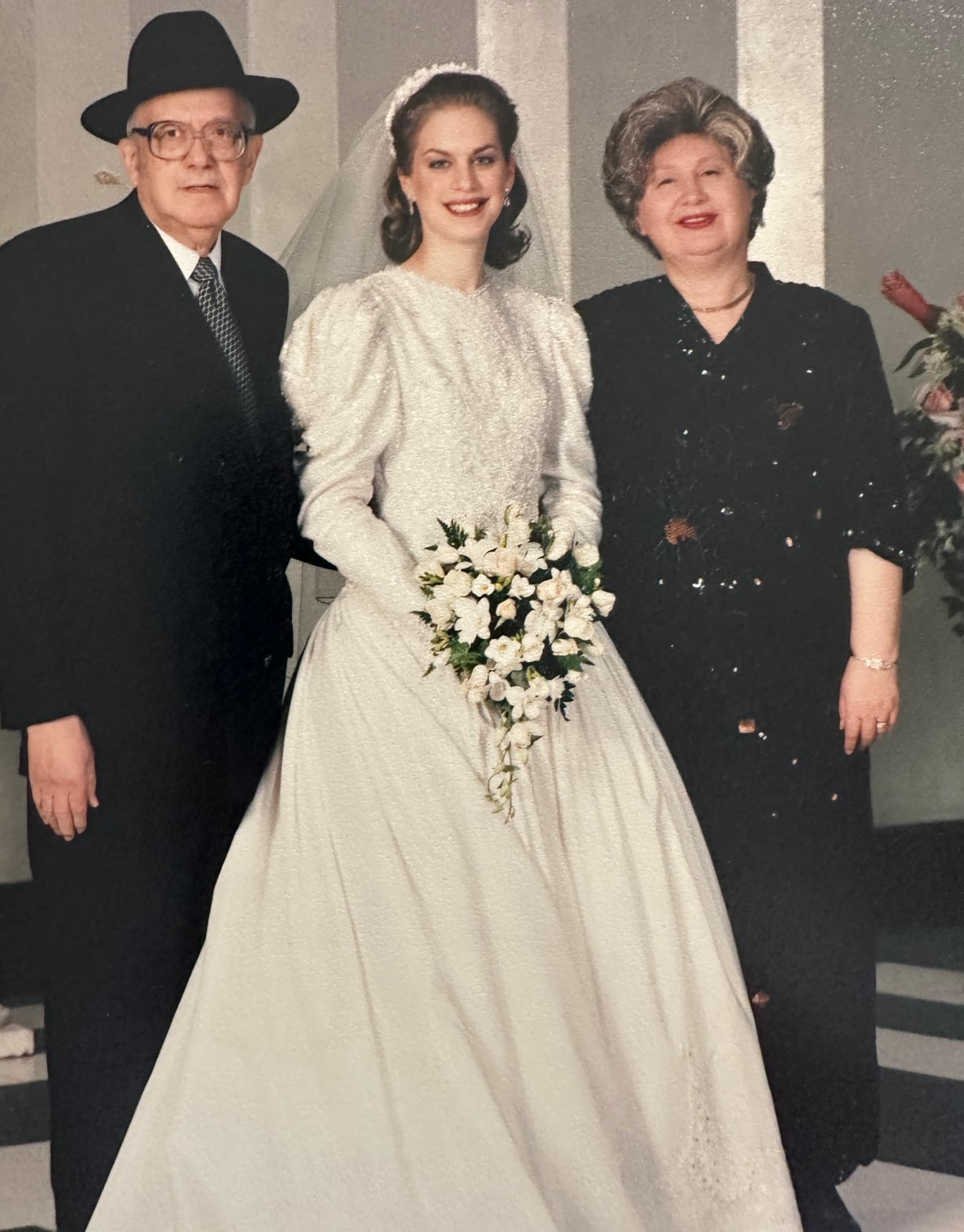 Zeidy and Bobby standing beside the kallah on her wedding day