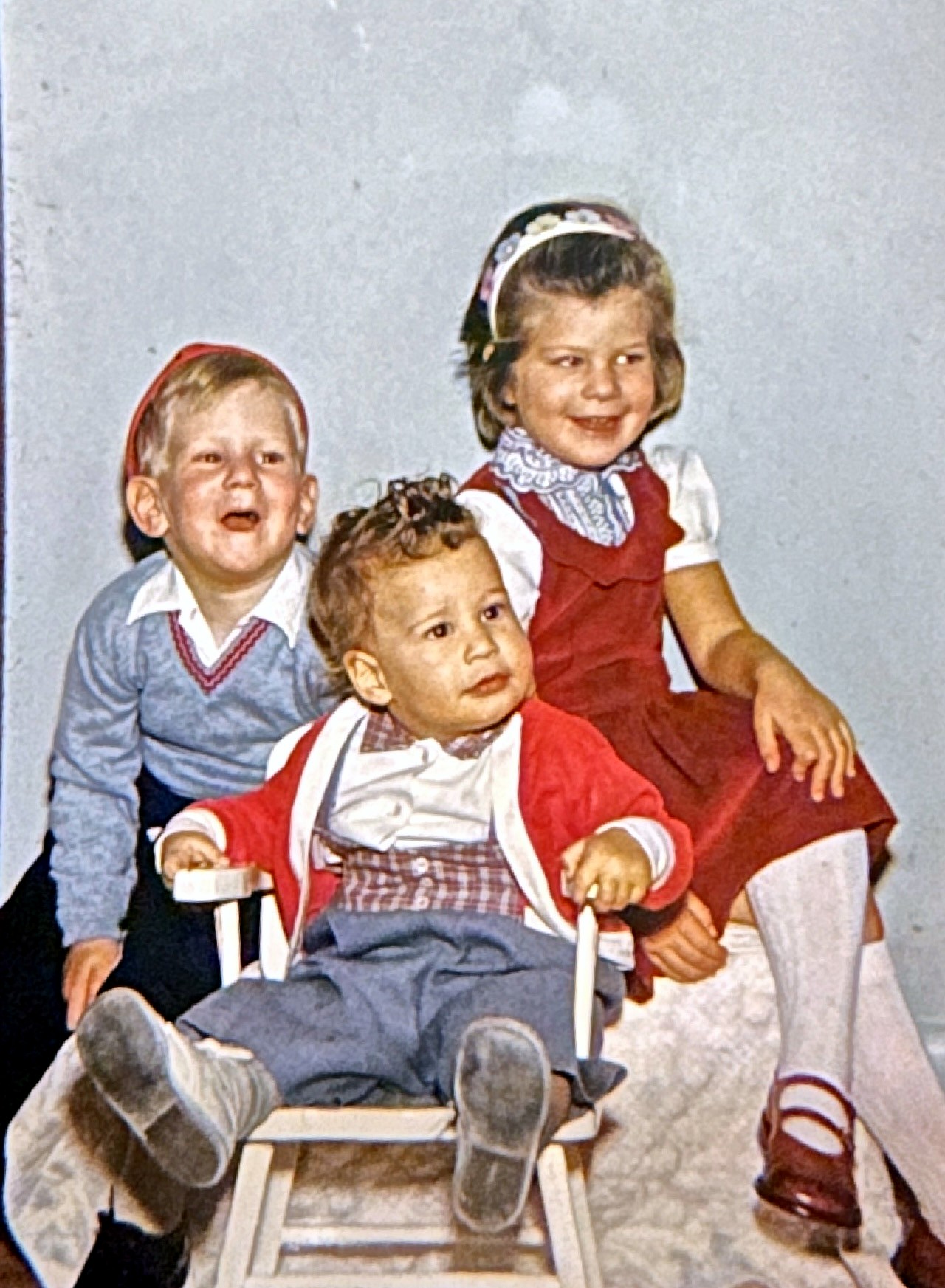The Rubenstein children laughing in a studio portrait