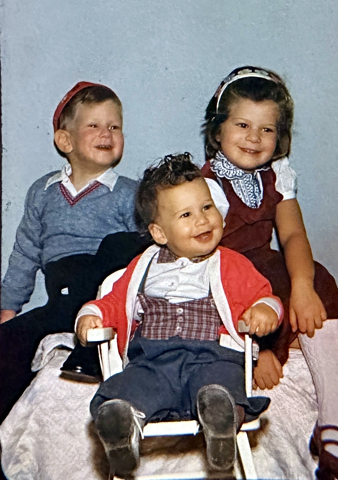 The three Rubenstein children laughing together in a studio portrait