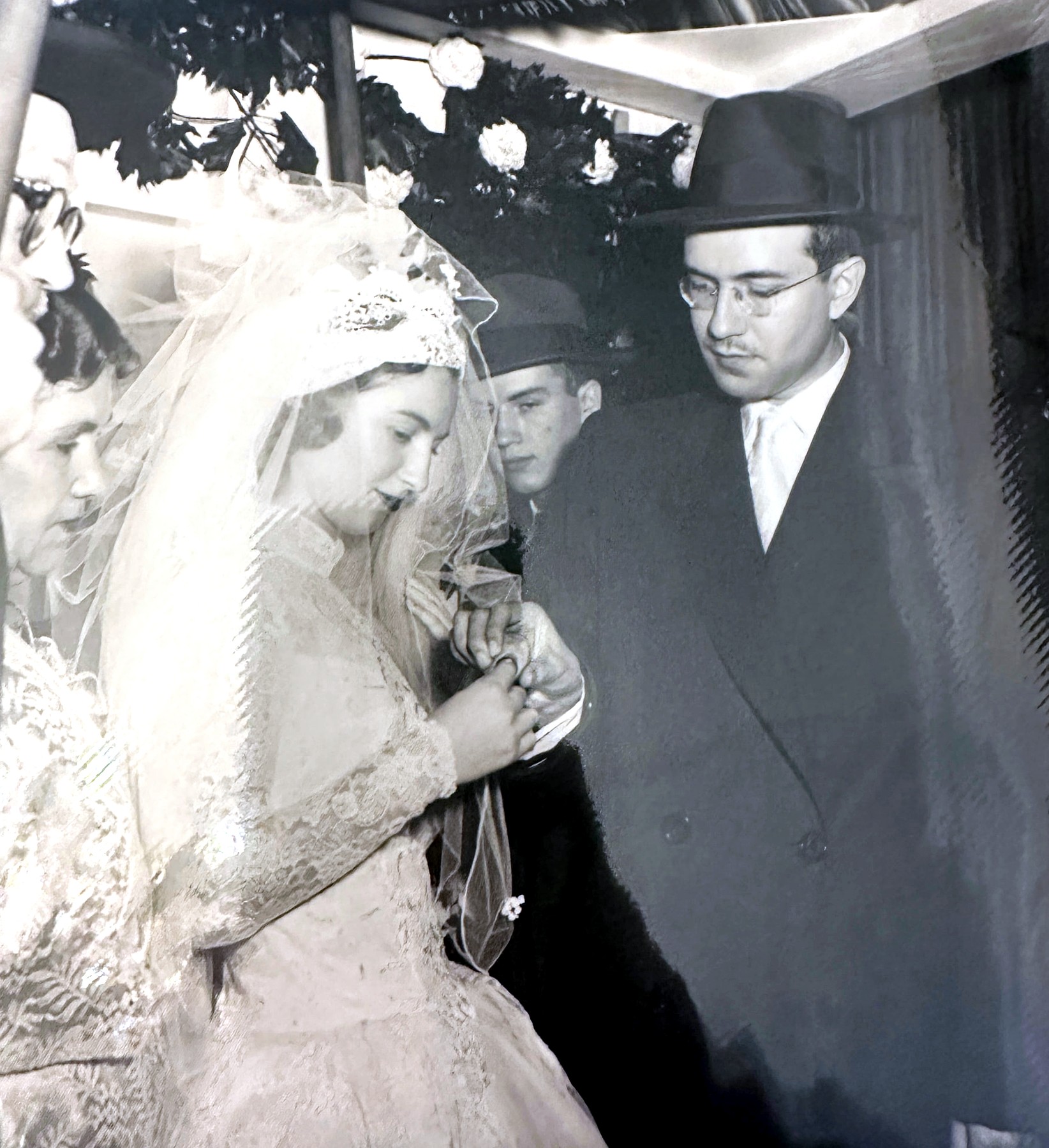 Izzy placing the ring on Esther's finger under the chuppah